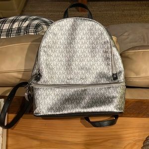sliver and black Michael Kors purse backpack